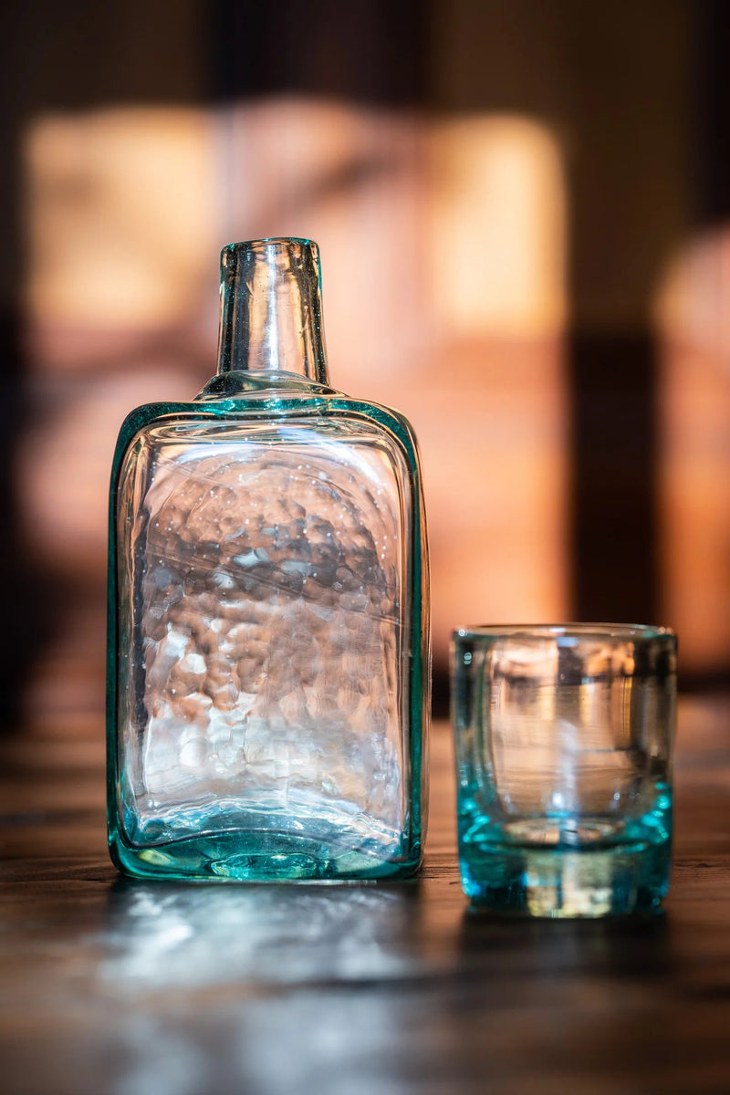 https://www.madetrade.com/cdn/shop/products/recycled-glass-carafe-tumbler-set-drinkware-magda-made-487930_800x.webp?v=1697497557