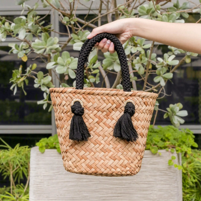 https://www.madetrade.com/cdn/shop/products/small-straw-tote-bag-with-braided-handles-handbags-likha-337045_800x.webp?v=1684871541
