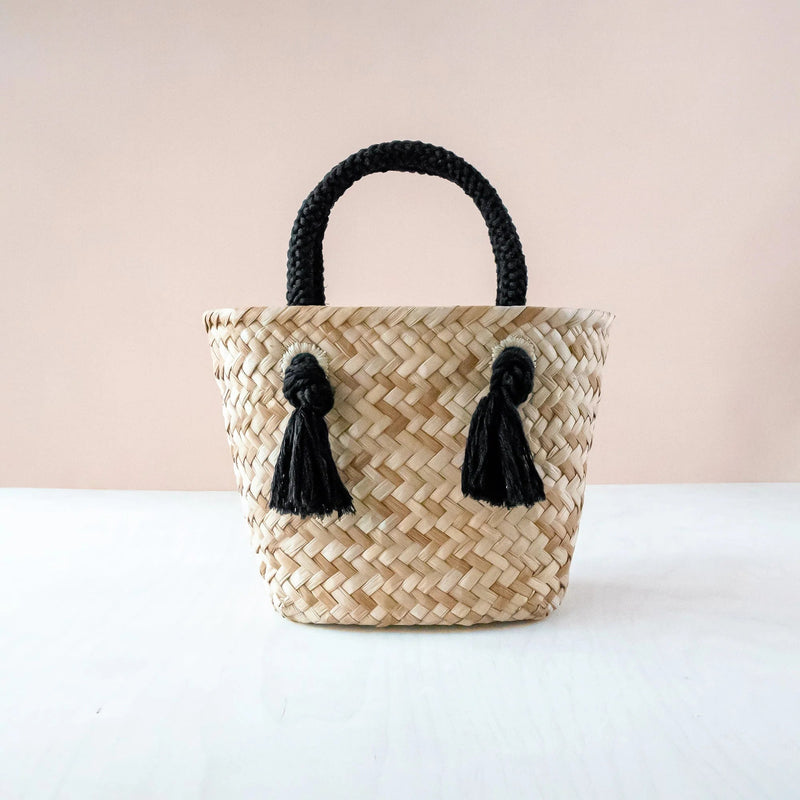 https://www.madetrade.com/cdn/shop/products/small-straw-tote-bag-with-braided-handles-handbags-likha-black-875270_800x.webp?v=1684871541